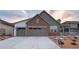 Charming home featuring a two-car garage, brick accents, and professionally landscaped front yard at 3856 Treadway Pt, Castle Rock, CO 80108
