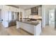 Modern kitchen featuring stainless steel appliances, white cabinetry, and a large island with a sink at 3856 Treadway Pt, Castle Rock, CO 80108