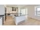 Modern kitchen with stainless steel appliances, an island with seating, and hardwood flooring at 3856 Treadway Pt, Castle Rock, CO 80108