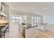 Open concept kitchen boasts modern appliances, a large island, and access to the living area at 3856 Treadway Pt, Castle Rock, CO 80108