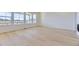 Bright and spacious living room featuring pristine white walls, light hardwood floors and large windows at 3856 Treadway Pt, Castle Rock, CO 80108