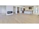Open-concept living room and kitchen with fireplace and hardwood floors at 3856 Treadway Pt, Castle Rock, CO 80108