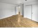 Bright bedroom with light wood laminate flooring and a large closet at 4450 S Pitkin St # 128, Aurora, CO 80015