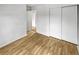 Bright bedroom with light wood laminate flooring and a large closet at 4450 S Pitkin St # 128, Aurora, CO 80015