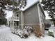 Gray condo building exterior with snowy landscaping at 4450 S Pitkin St # 128, Aurora, CO 80015