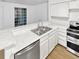 White kitchen with stainless steel appliances and granite countertop at 4450 S Pitkin St # 128, Aurora, CO 80015