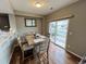 Dining area with wooden table and access to backyard patio at 23080 York Ave, Parker, CO 80138
