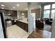 Kitchen with dark brown cabinets, stainless steel appliances, and tile flooring at 23080 York Ave, Parker, CO 80138