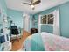 Bright bedroom with light blue walls, wood floors, ceiling fan, and unique mermaid-themed bedding at 6720 S Adams Way, Centennial, CO 80122