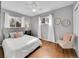 Cozy bedroom featuring hardwood floors, ceiling fan, neutral paint, and natural light at 6720 S Adams Way, Centennial, CO 80122