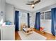 Bright bedroom featuring hardwood floors, ceiling fan, and natural light at 6720 S Adams Way, Centennial, CO 80122