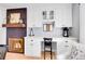 Dining area with custom white cabinetry with a desk and a built-in fireplace at 6720 S Adams Way, Centennial, CO 80122