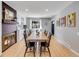 Dining room featuring hardwood floors, a long table, and plenty of natural light at 6720 S Adams Way, Centennial, CO 80122