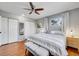 Bright main bedroom featuring hardwood floors, ceiling fan, ensuite bath, and natural light at 6720 S Adams Way, Centennial, CO 80122