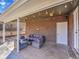 Covered patio area with comfortable seating, brick accents, and outdoor charm at 6720 S Adams Way, Centennial, CO 80122