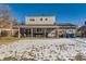 House with backyard patio and snowy yard at 4611 S Kalispell Way, Aurora, CO 80015