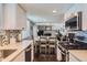 Open concept kitchen with stainless steel appliances and view into the living room at 4611 S Kalispell Way, Aurora, CO 80015