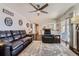 Living room with hardwood floors, ceiling fan, and access to backyard at 4611 S Kalispell Way, Aurora, CO 80015