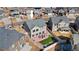 Aerial view of the home with a spacious fenced backyard, patio, and green lawn at 18284 E 52Nd Pl, Denver, CO 80249