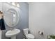 This half bathroom has a pedestal sink and modern fixtures at 18284 E 52Nd Pl, Denver, CO 80249
