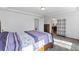 Well-lit bedroom featuring a large bed, access to the bathroom, and minimalist shelving at 18284 E 52Nd Pl, Denver, CO 80249