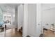 Bright hallway with wood floors, staircase, and a half-bath. The living room is visible in the background at 18284 E 52Nd Pl, Denver, CO 80249