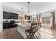 Modern kitchen features an island, breakfast bar, dark cabinetry, and stainless steel appliances at 18284 E 52Nd Pl, Denver, CO 80249