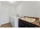 Practical laundry room features modern appliances and countertop space for folding and storage at 18284 E 52Nd Pl, Denver, CO 80249