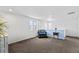 Bright living room with large windows, chair, and a serene ambiance at 18284 E 52Nd Pl, Denver, CO 80249