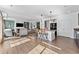 Bright, open-concept living space with hardwood floors, a fireplace, and seamless flow to the kitchen at 18284 E 52Nd Pl, Denver, CO 80249