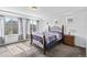 Well-lit main bedroom with decorative bed frame, side tables, and large windows dressed with patterned curtains at 18284 E 52Nd Pl, Denver, CO 80249