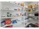 Walk-in pantry featuring ample shelving for organized food and household storage at 18284 E 52Nd Pl, Denver, CO 80249