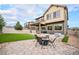Spacious backyard with a patio, fire pit, and well-manicured lawn at 1027 Auburn Dr, Erie, CO 80516