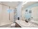 Bright bathroom with white tiled tub, granite countertop, and a large mirror at 1027 Auburn Dr, Erie, CO 80516