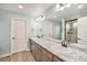 Bathroom boasts double sinks with granite counters and updated fixtures at 1027 Auburn Dr, Erie, CO 80516