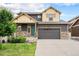 Beautiful two-story home with a teal front door and well-maintained landscaping at 1027 Auburn Dr, Erie, CO 80516