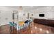 Open kitchen featuring a large island, stainless steel fridge, and hardwood floors at 1027 Auburn Dr, Erie, CO 80516