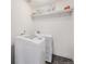 Clean laundry room with modern appliances and shelving for storage at 1027 Auburn Dr, Erie, CO 80516