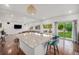 Open kitchen and living space with hardwood floors and sliding glass doors to the backyard at 1027 Auburn Dr, Erie, CO 80516