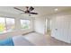 Bright main bedroom features abundant natural light, neutral carpeting, and a ceiling fan for added comfort at 1027 Auburn Dr, Erie, CO 80516