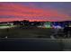 Neighborhood view with stunning sunset, showcasing community green space and holiday lighting at 1027 Auburn Dr, Erie, CO 80516