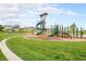 A community playground with a winding slide, swings, and climbing equipment with views of nearby homes at 1027 Auburn Dr, Erie, CO 80516