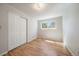 Bright bedroom featuring hardwood floors, a large window for great tree-filled views, and a closet at 29827 Gigi Rd, Evergreen, CO 80439