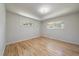 Bright, light-filled bedroom features hardwood floors, fresh paint, and large windows with green, tree-filled views at 29827 Gigi Rd, Evergreen, CO 80439
