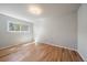 Well-lit bedroom with hardwood floors, fresh paint, and a large window for great tree-filled views at 29827 Gigi Rd, Evergreen, CO 80439