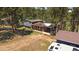 Multi-level home with brick and gray siding nestled among tall pine trees, offering a serene setting at 29827 Gigi Rd, Evergreen, CO 80439