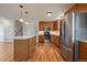 Charming kitchen featuring light wood cabinets, stainless steel appliances, and an eat-in island with pendant lighting at 29827 Gigi Rd, Evergreen, CO 80439