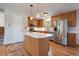Well-equipped kitchen with wood cabinets, stainless steel appliances, and hardwood floors at 29827 Gigi Rd, Evergreen, CO 80439