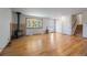 Bright living area with hardwood floors, a wood-burning stove, and a view of the entry way and staircase at 29827 Gigi Rd, Evergreen, CO 80439