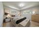Primary bedroom featuring hardwood floors, neutral decor, and two windows for natural light, plus a comfortable bench at 29827 Gigi Rd, Evergreen, CO 80439